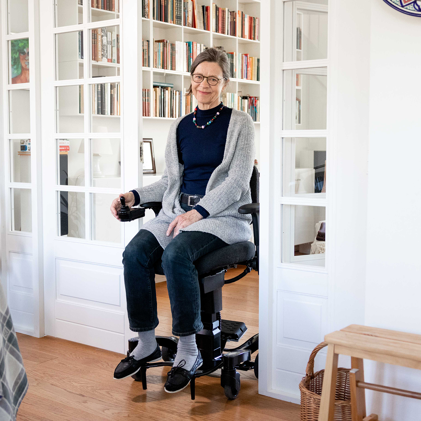 Woman in electric office chair with brakes entering kitchen effortlessly